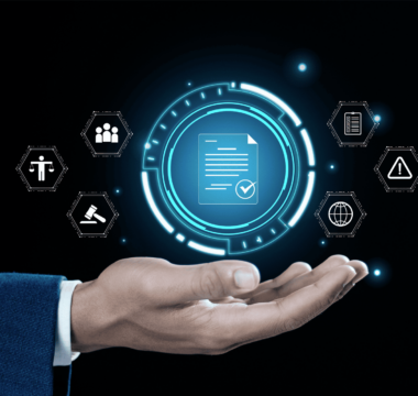 A businessperson’s hand presenting a digital interface with a document icon at the center, surrounded by legal and compliance-related icons including a gavel, checklist, warning sign, globe, and balance scale, symbolizing digital governance and regulatory compliance.